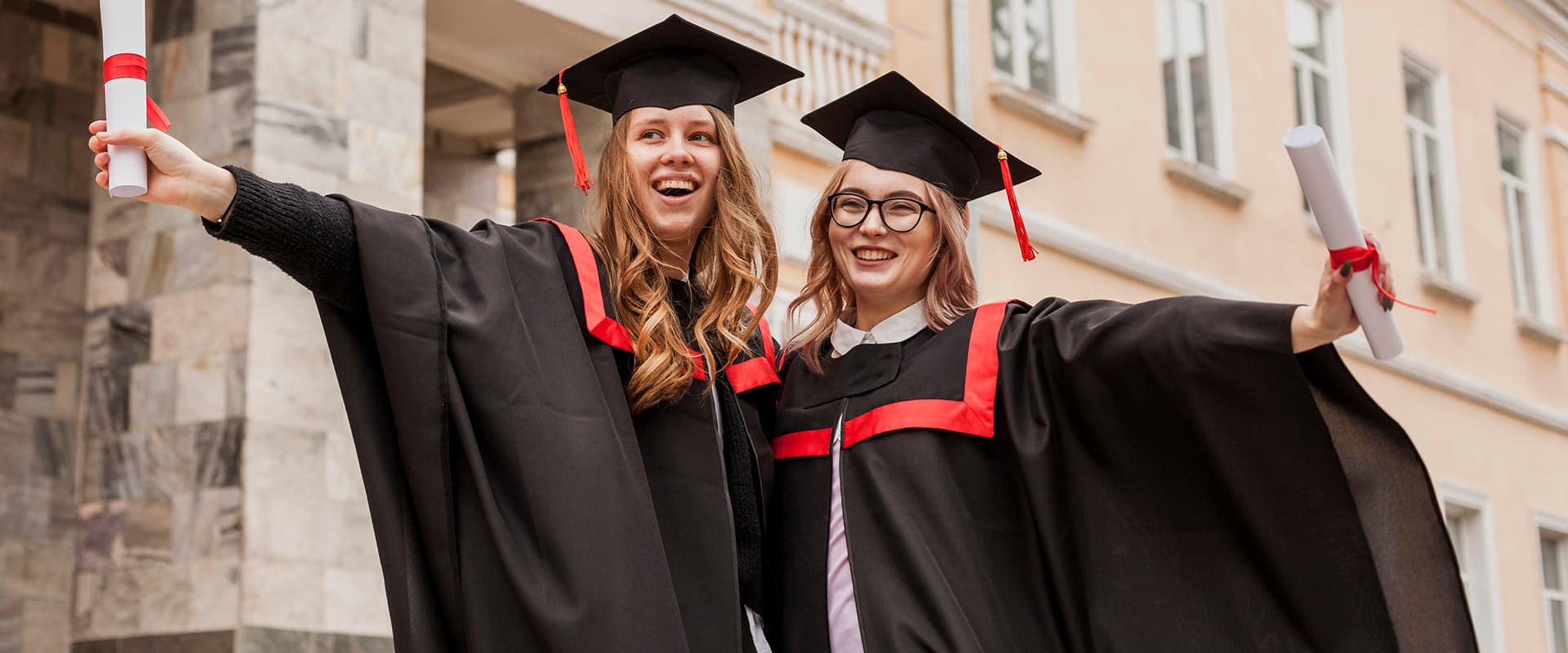 Woodcroft University graduates holding their diplomas